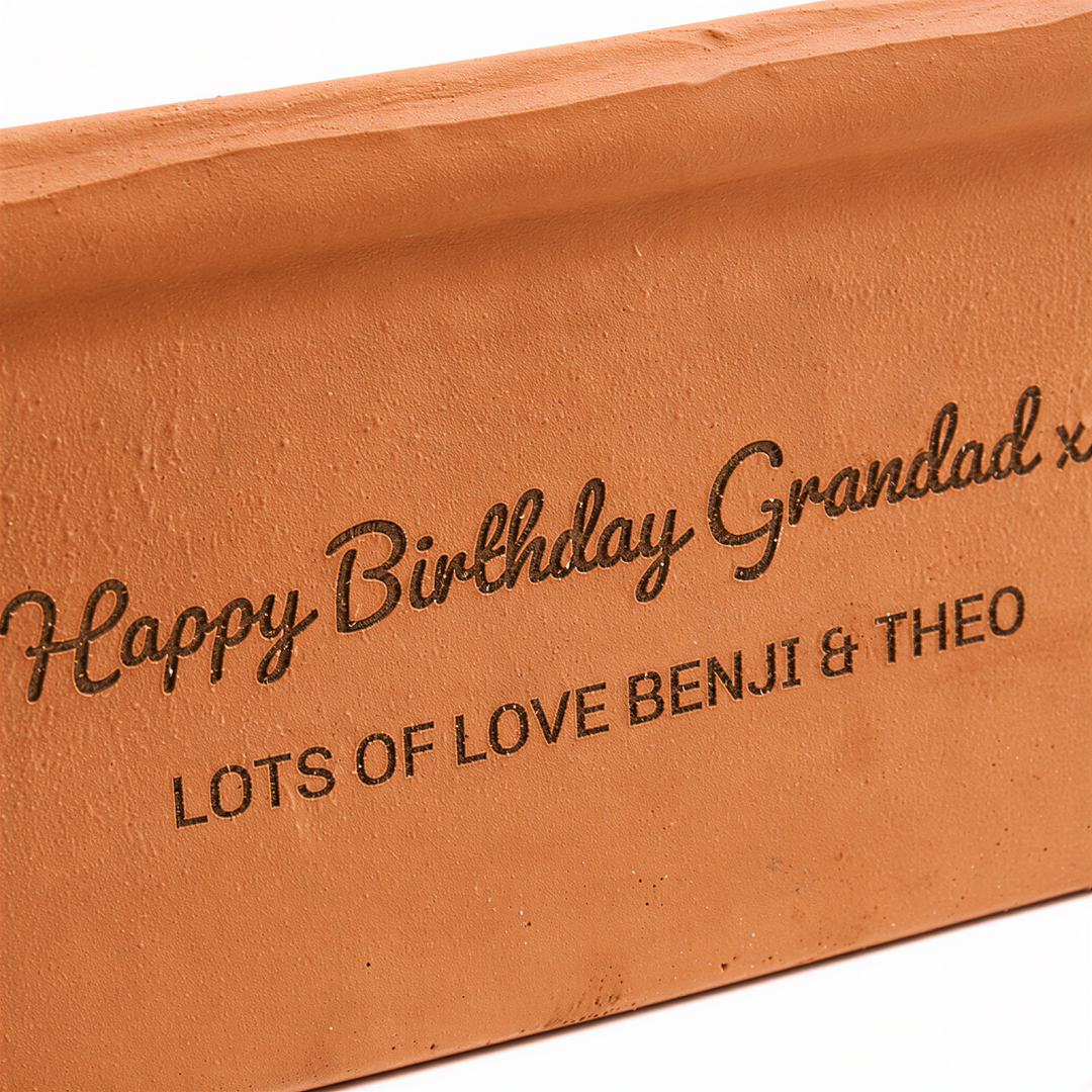 A brick with the text "Happy Birthday Grandad x Lots of Love Benji &amp; Theo" engraved on it.
