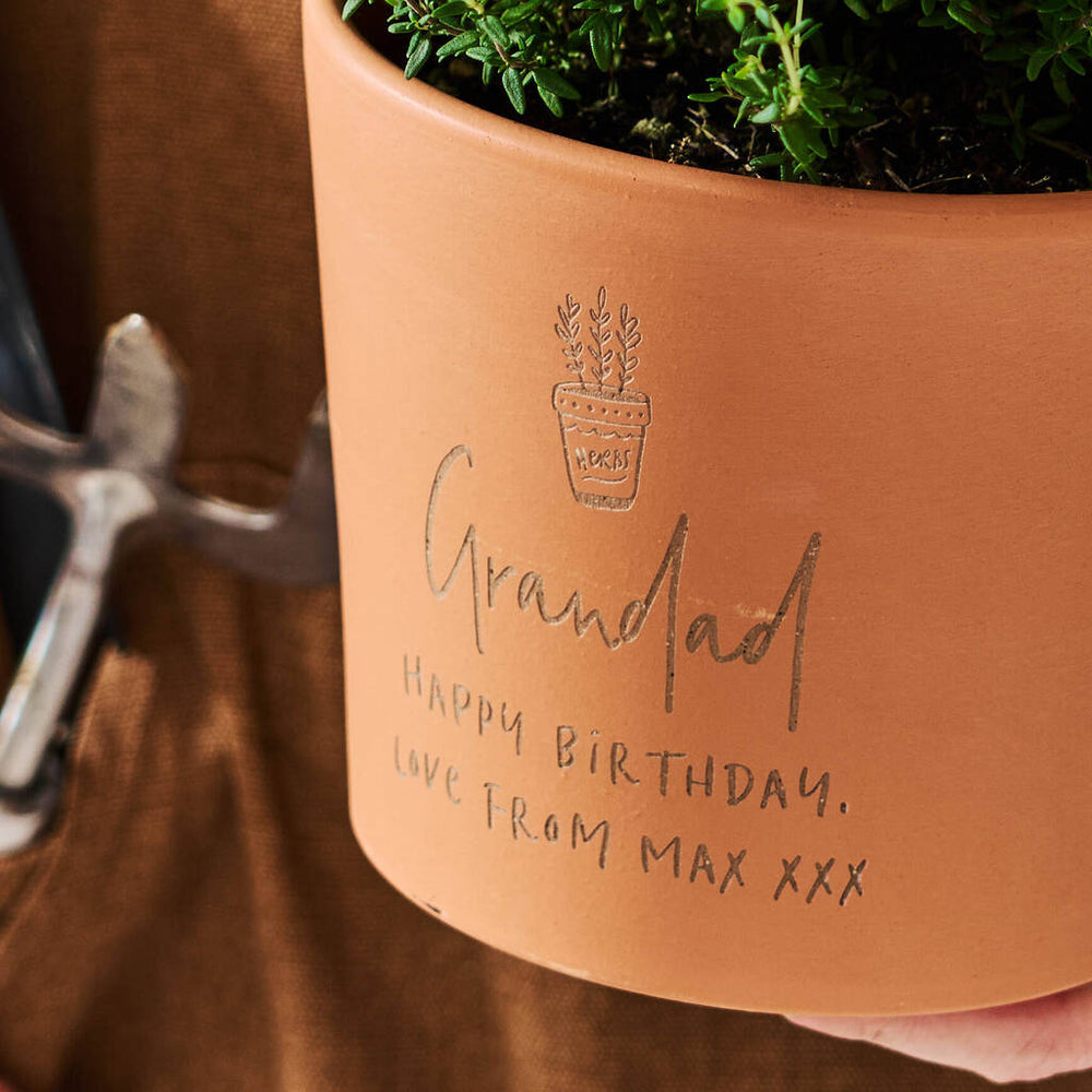 Personalised birthday gift for gardeners terracotta plant pot engraved with a name and message.