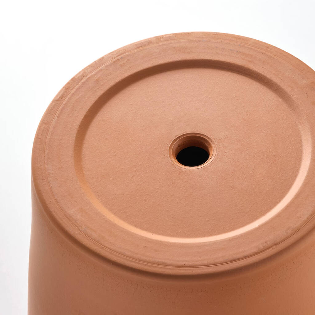 Top view of a terracotta plant pot with drainage hole, perfect as a gift for gardeners.
