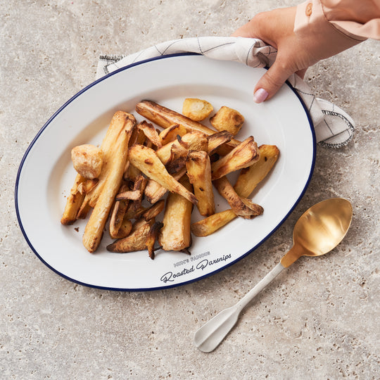 Top-down view of personalised enamel platter engraved with 'Mum’s Famous Roasted Parsnips', loaded with oven-roasted parsnips. Thoughtful gift for mum, farmhouse kitchen decor, ideal for family meals, holiday dinners and personalised home cooking gifts.