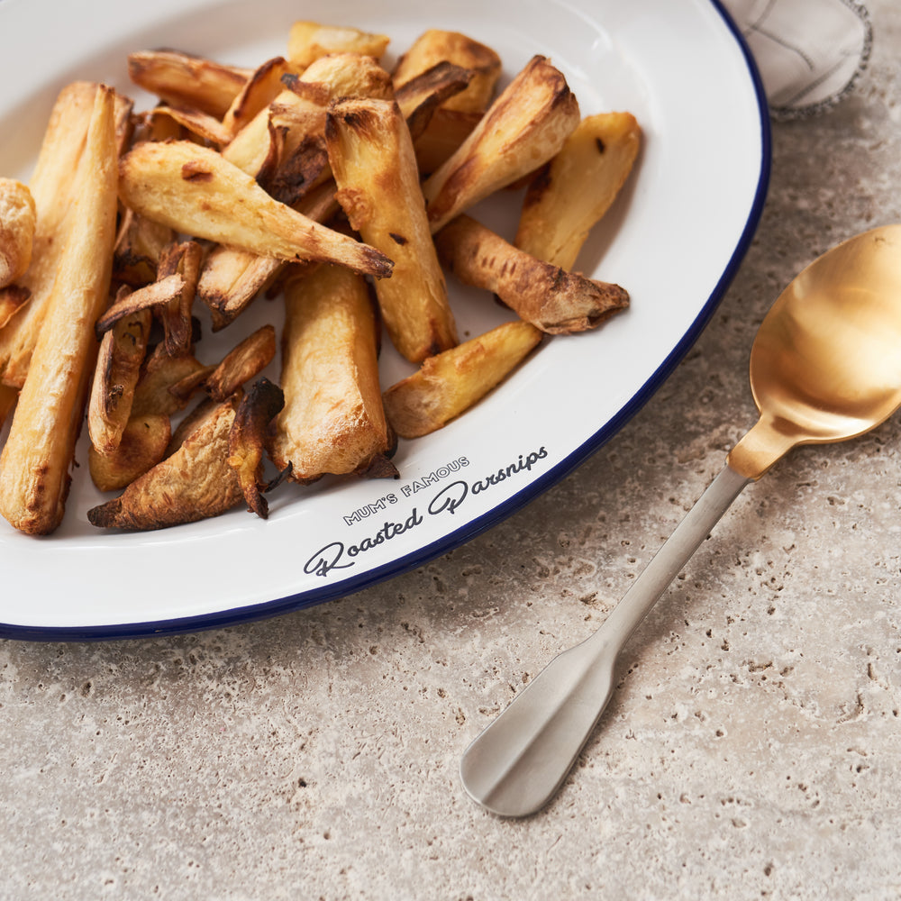 Personalised enamel serving platter engraved with 'Mum’s Famous Roasted Parsnips', filled with golden roasted parsnips. Unique gift for mums, enamel tray for Sunday roasts, Christmas dinner or festive occasions. Durable, custom family serveware.