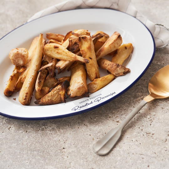 Personalised enamel serving platter engraved with 'Mum’s Famous Roasted Parsnips', filled with golden roasted parsnips. Unique gift for mums, enamel tray for Sunday roasts, Christmas dinner or festive occasions. Durable, custom family serveware.